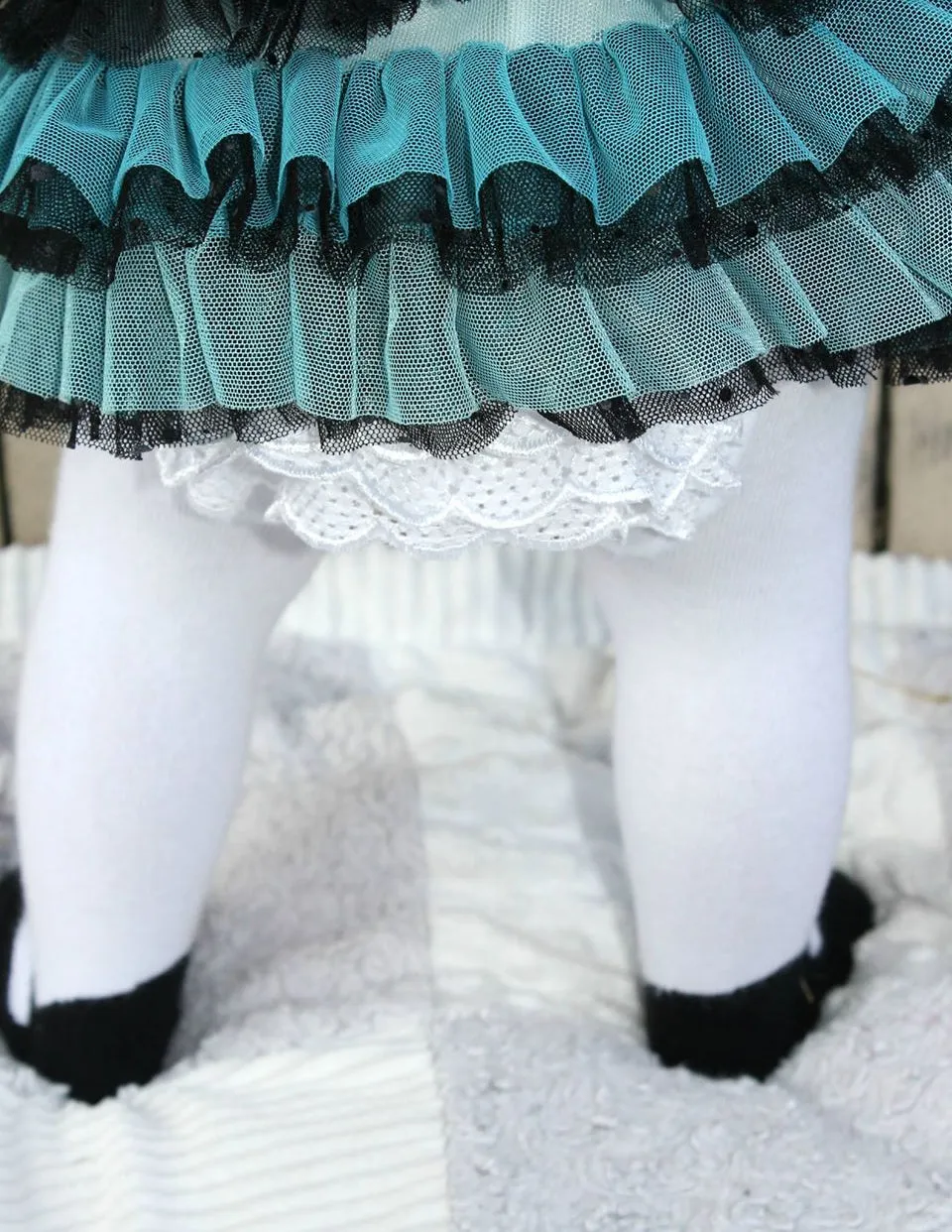 Baby girl ruffle bottom tights with sewn-in black shoe design.  Anti-slip soles. 0-6 months